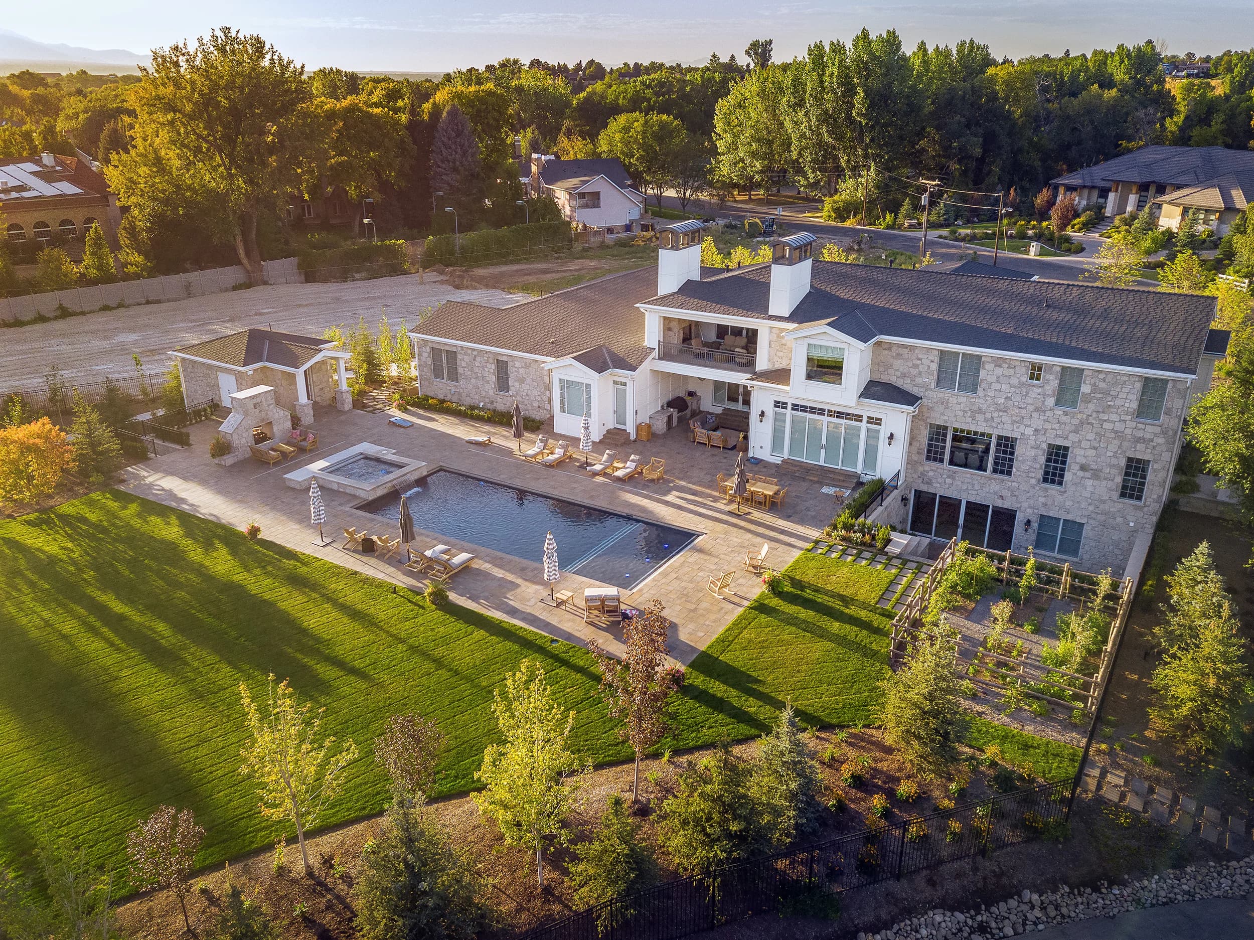 Aerial daylight view of a Big Rock Landscaping estate with custom pool, pool deck, and mature plantings in Provo, Utah