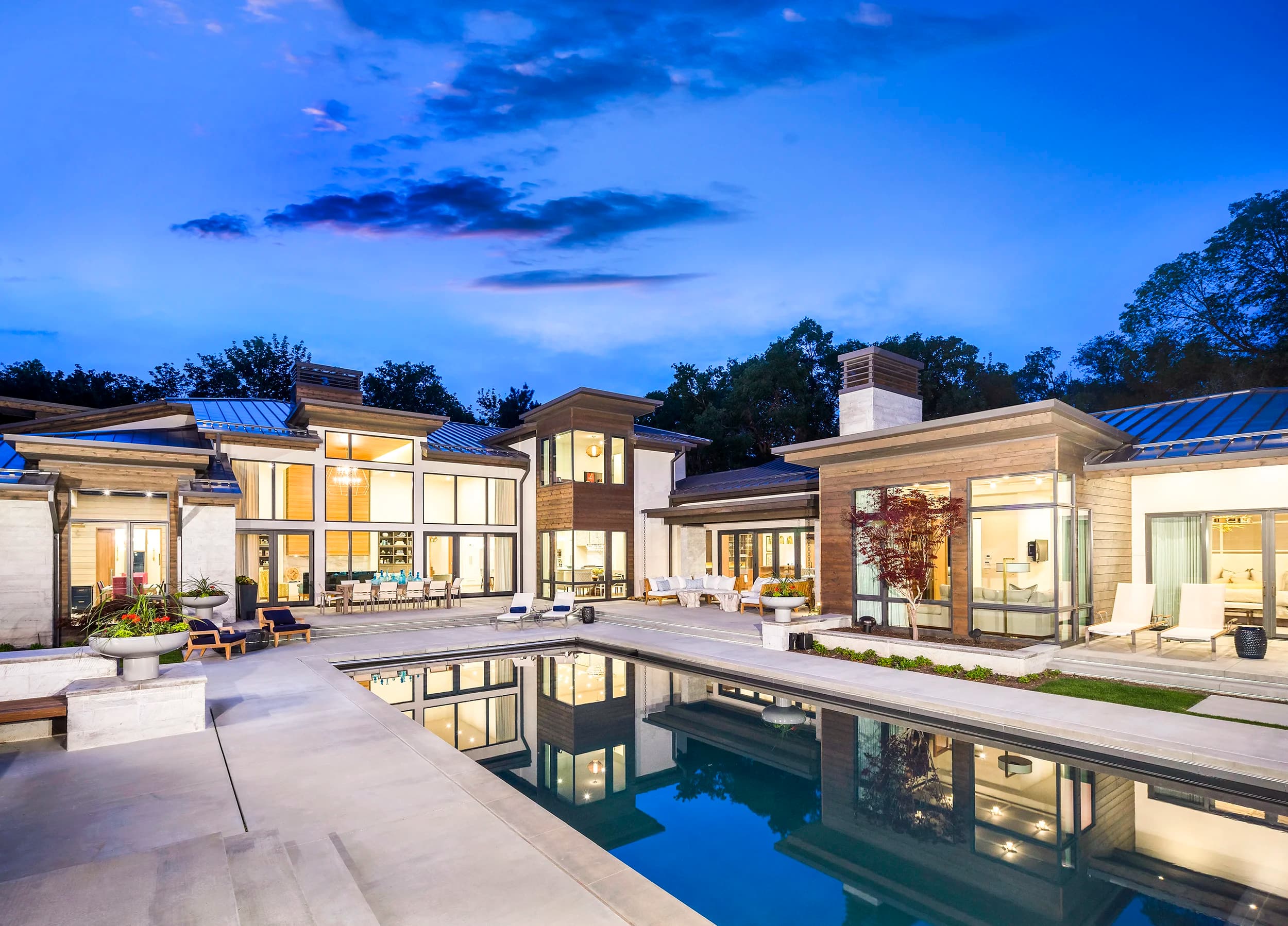 Contemporary multi-wing Big Rock estate with reflecting pool, modern plantings, and twilight lighting on Country Manor Lane in Alpine, Utah